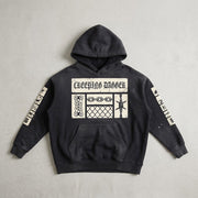 Creeping Panel Vintage Washed Frayed Hoodie in washed black, front patch panel and sleeve patches, laid flat on a light surface