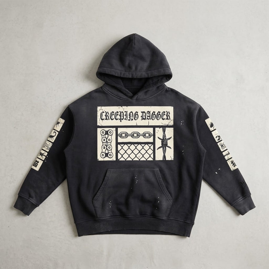 Creeping Panel Vintage Washed Frayed Hoodie in washed black, front patch panel and sleeve patches, laid flat on a light surface