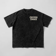 Dealer Snow Washed Oversized Tee in washed black, front view with cream Creeping Dagger chest logo