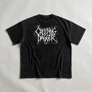 Sacred Mary Snow Washed Oversized Tee, front with white Creeping Dagger logo on washed black cotton