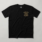Shady Jay's Bail Bonds Tee in black, front view with small gold chest graphic and Creeping Dagger neck mark
