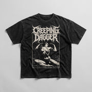Suffering Moon Snow Washed Oversized Tee in washed black laid flat, with Creeping Dagger logo and seated figure graphic